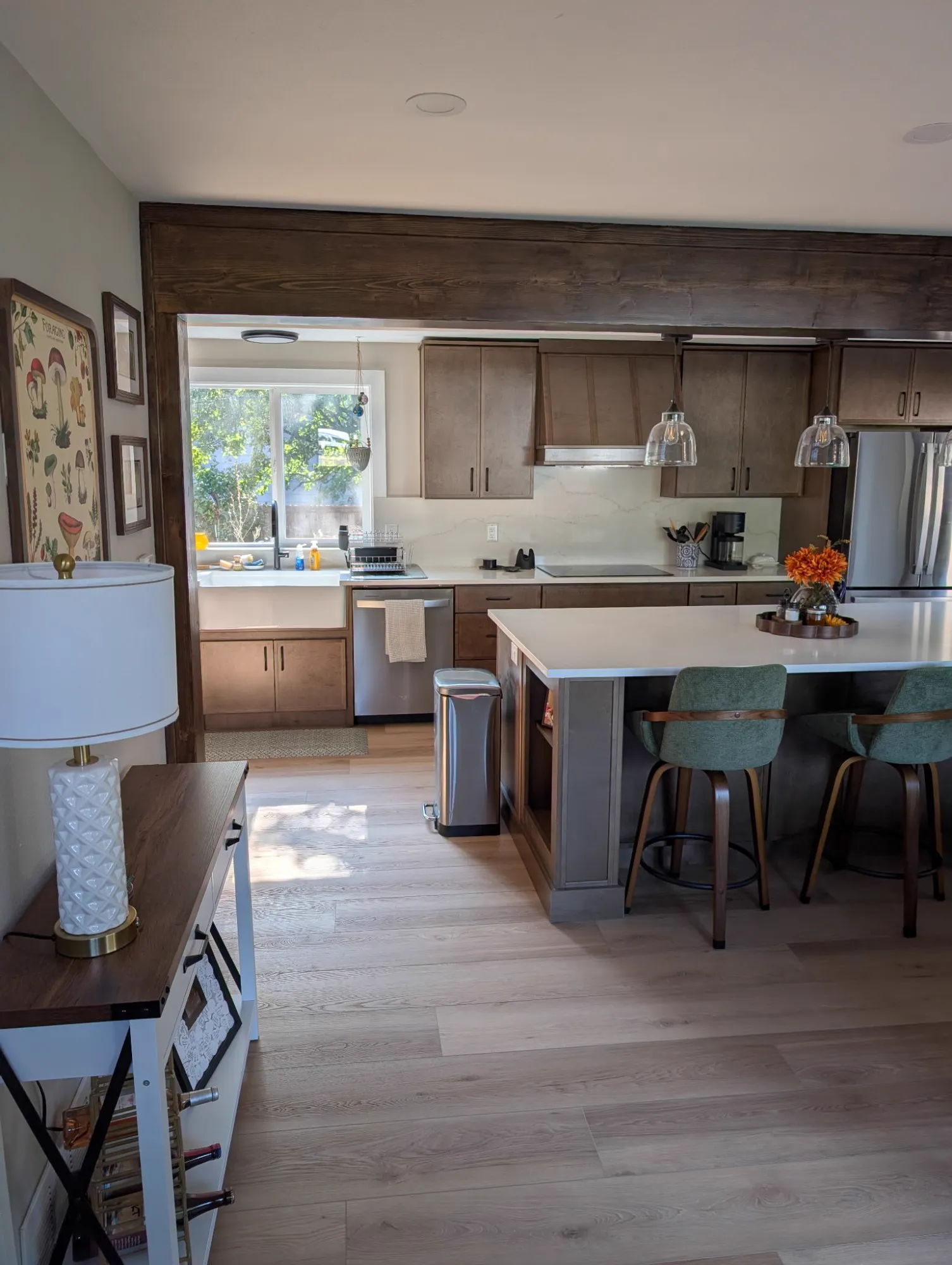 View into the kitchen through a stained wood beam opening